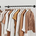 Stylish Wooden Clothes Hangers Holding Various Neutral Toned Sweaters And Shirts
