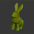 Golden Rabbit Statue In Sitting Position With Shiny Metallic Finish Against Dark Background