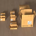 Open cardboard boxes of various sizes on wooden floor with labels and text