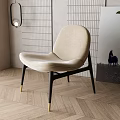 Modern Beige Velvet Accent Chair With Black Metal Legs On Herringbone Wooden Floor