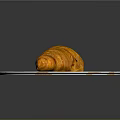 Golden Croissant On White Plate With Orange Croissant Patterns