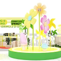 Exhibition Booths With White Canopies Green Yellow Decorations Plants And Circular Central Area