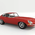 Red Classic Jaguar Sports Car With Sleek Body And Vintage Chrome Accents