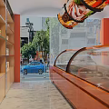 Vibrant Food Shop Interior With Orange Walls Glass Display Case Wooden Shelves And Marble Floor