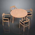 Round Wooden Dining Table With Four Chairs And Black Cushions