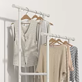 Simple Wardrobe Display With Hanging Clothes Including Vest Knitwear And Striped Shirts