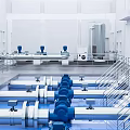 Industrial Facility Interior With Blue Pumps Pipes And Metal Railings