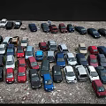 Parking Lot Full of Various Colored Cars And Different Vehicle Models Densely Parked