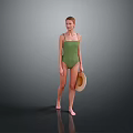 Woman Wearing Green One Piece Swimsuit Holding Straw Hat Against Gray Background