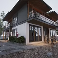 Traditional Ancient Building With Wooden Balcony Stone Lanterns And Green Plants Surrounded By Trees