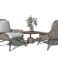 Modern Rattan Table and Chairs Set Featuring Gray Cushions Black Metal Legs and Vase Flowers