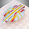 Colorful Origami Airplane Model With Red Yellow White Gray On Textured Mat