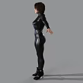 Woman In Sleek Black Leather Bodysuit With Arms Outstretched Against Gray Background