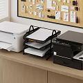 Office Electronics With White And Black Printers And Document Tray On Wooden Desk