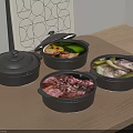 Three Black Casserole Pots With Various Foods Inside On Wooden Countertop