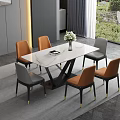 Modern Dining Table Set With White Marble Top And Orange Gray Chairs And Flower Vase