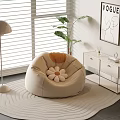Beige Single Sofa with Flower Shaped Cushion Floor Lamp Green Plant and Wave Patterned Rug