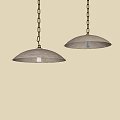 Two Modern Pendant Lights Hanging From Chains With Illuminated Bulbs Against Neutral Wall