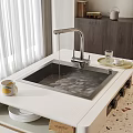 Stainless Steel Kitchen Sink With Water Flowing From Faucet On Countertop