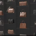 Various Stylish Handbags Displayed On Black Shelves Featuring Brown Black Gray And Quilted Leather Patterns