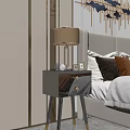 Modern Glossy Black Bedside Table With Table Lamp Photo Frames And Decorative Items In Bedroom
