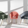 Stylish Leisure Chairs Green Pink And Dark Blue With Wooden Legs Against White Wall Background