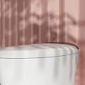 Modern White Toilet Design In Bathroom With Pink Curtain And Green Plant Decor