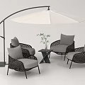 Stylish Outdoor Wicker Sofa Set with Umbrella Side Table Green Plant and Comfortable Gray Cushions