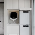 Home Balcony Laundry Space With White Cabinets Countertop Faucet And Stacked Appliances