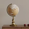 Vintage Globe With Golden Base Decorative Piece On Wooden Table And Red Fruits