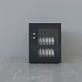 Modern Black Kitchen Dish Sterilizer Appliance With White Dishes On Marble Countertop