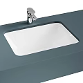 Modern White Undermount Washbasin With Silver Faucet On Gray Bathroom Countertop