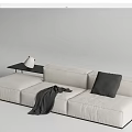 Beige Sectional Sofa Featuring Gray Pillow Blanket and Black Side Table with White Vase