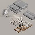 Gray and Beige Towels Folded and Rolled with Bath Products Bottles Candles Soap and Tray