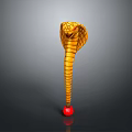Golden Cobra With Striped Body Flattened Head And Red Ball Base On Dark Background
