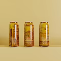 Three Beverage Cans with Yellow and Brown Patterns on Light Yellow Background