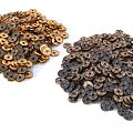 Two Piles Of Buttons With Golden And Dark Brown Colors On White Background