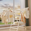 Indoor Clothes Drying Rack With Baby Clothes Striped T-shirt And Plush Toys In Natural Light