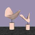 Curved Metallic Sculptures Displayed On Copper Bases Against Purple Background And Marble Surface