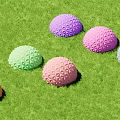 Colorful Hemispherical Decorative Hanging Ornaments With Geometric Patterns On Green Grass
