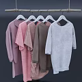 Clothes On Coat Hangers Hanging From Wooden Rod With Pink Brown And Gray Colors
