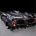 Gray Convertible Sports Car With Red Seats And Black Wheels Against Ancient Stone Columns