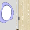 Irregular Shaped Beige Frame Mirror Reflecting Black Doll With X Eyes In Modern Interior