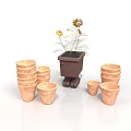 Sunflower Plant In Brown Pot With Stacked Terracotta Pots Of Various Sizes