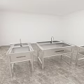White Interior Room Featuring Four Stainless Steel Sinks On Marble Floor