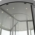 Modern Circular Revolving Door With Glass Panels And Metal Frame Entrance