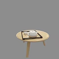Minimalist White Teapot With Black Tray On Light Colored Round Wooden Table