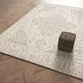Beige Square Rug With Gray Intricate Patterns On Herringbone Wooden Floor With Woven Stool Accent
