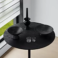 Decorative Ornament Set On Black Round Table With Black Bowls Candleholder And Glass Cups