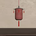 Red Mesh Chinese Lantern With Metal Frame And Tassels Hanging On Beige Wall